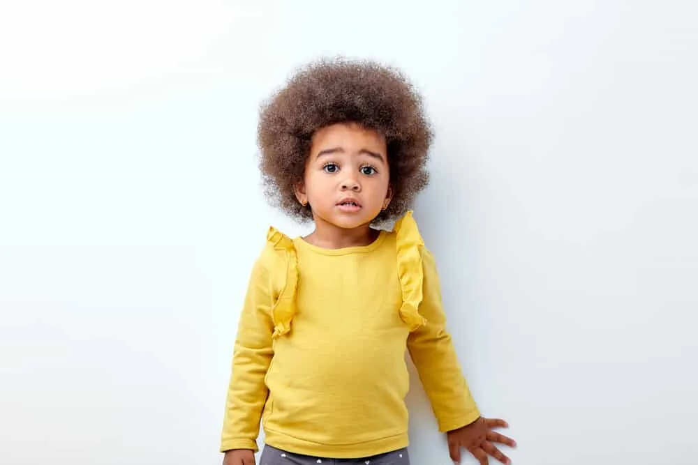 7 Cute & Easy Infant Black Baby Girl Hairstyles with Tutorials 9 A delightful African American toddler with longer hair than most kids her age wearing a wash-n-go hairstyle.