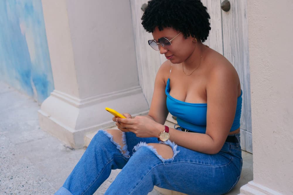 A lovely black female with short hair is wearing a curly, layered bob on her type 4 natural hair.