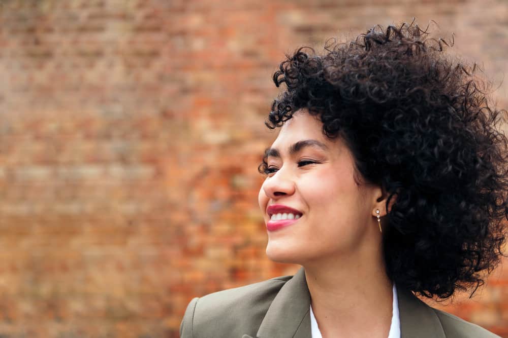 A young Latin woman with fine hair styled with a lightweight brush that contains natural boar bristles.