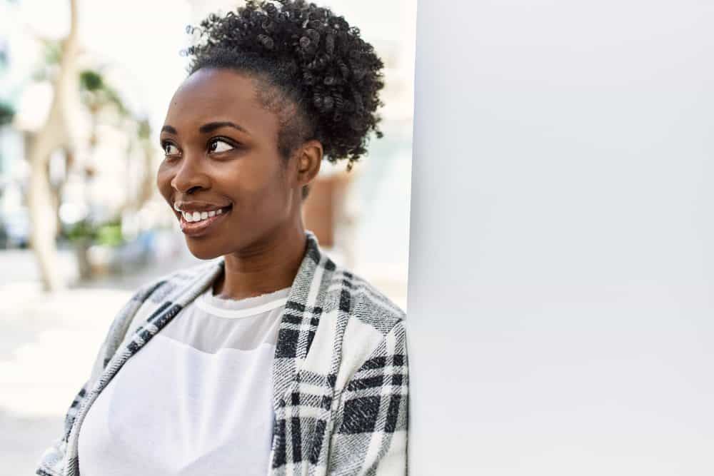 A lady that looks like a true queen rocks her natural curls colored with henna hair dye.