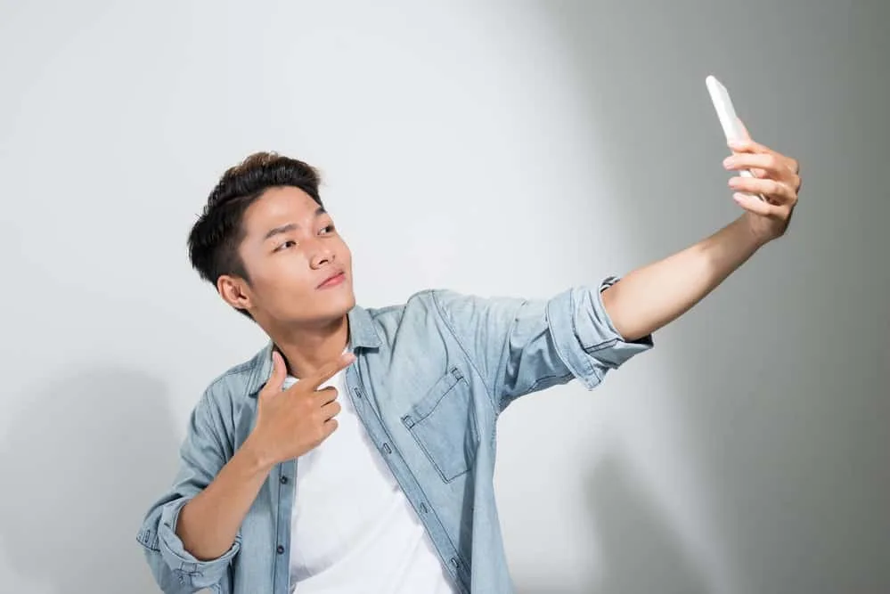 Asian Men Hairstyles: 15 Best Hairstyles for Asian Guys 22 A man with thin hair wearing an Asian hairstyle is elevating his 1C hair type and complementing his soft hair.