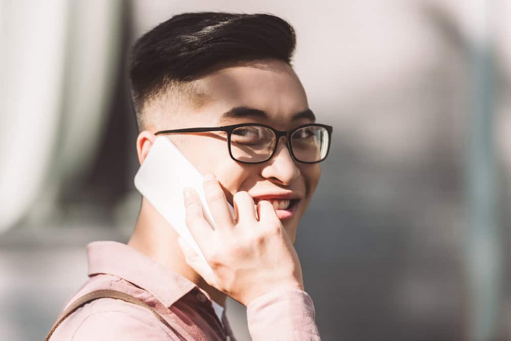 The two-block haircut with a defined texture gives this man's dark brown hair a sleek and modern look.