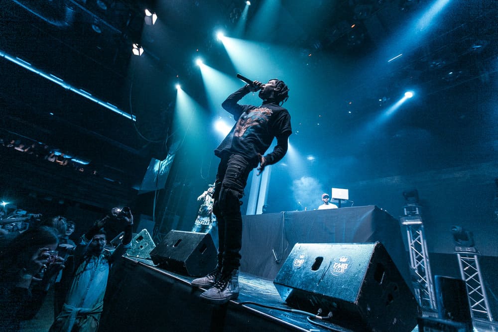 Travis Scott, rocking his famous knotless braids that have become a symbol of hip-hop culture.