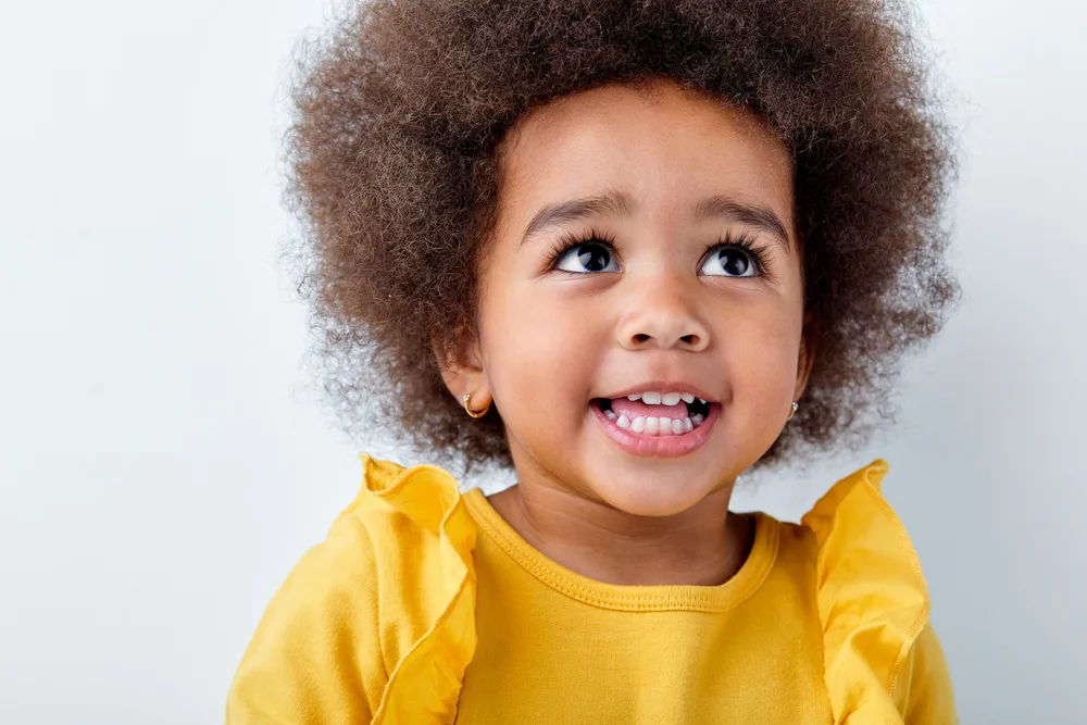 7 Cute & Easy Infant Black Baby Girl Hairstyles with Tutorials 4 An adorable toddler with a simple look that's perfect for a special occasion like a wedding or going to church.