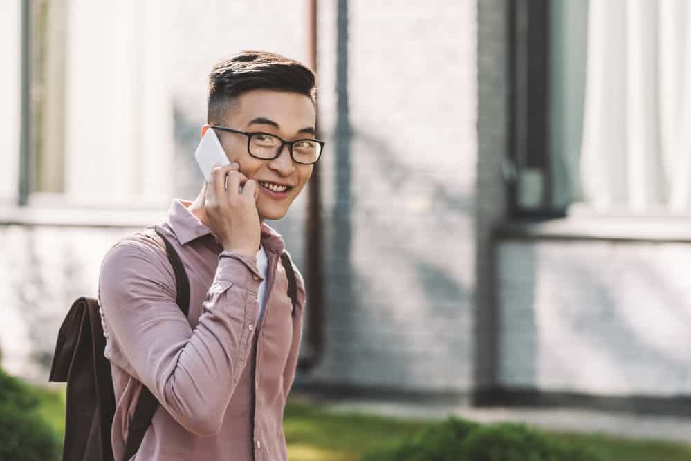 This Asian man is wearing a two-block haircut on thin hair, accentuating his unique features and dark brown hair.