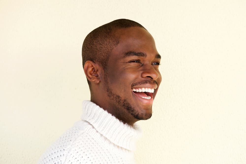 A fresh butch cut transforms this man's type 4 hair type and natural hairline into a classy hair style.