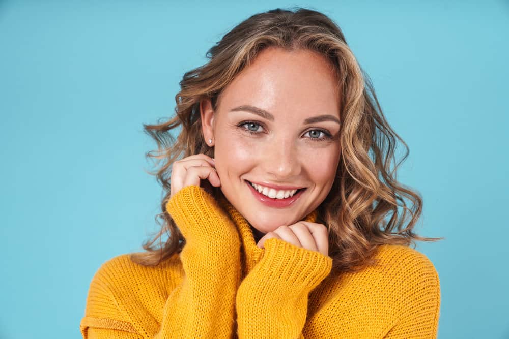 A white female with a wonderful smile experienced hair shaft damage after a DIY haircut on soaking wet hair.