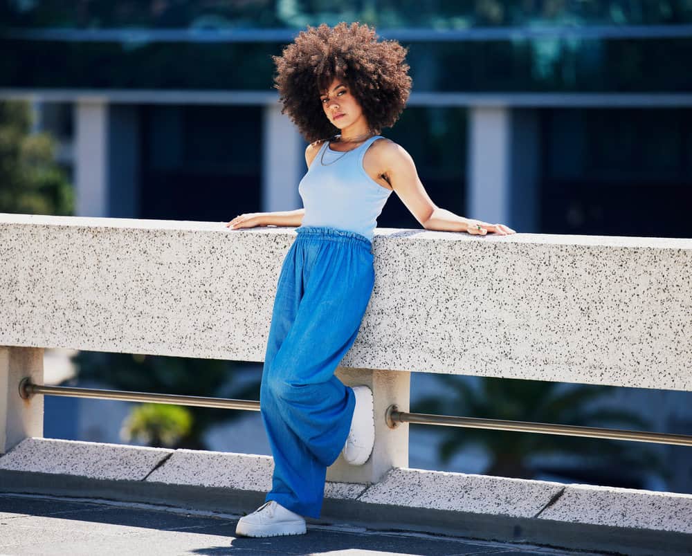 A cute African American female that has been using natural hair protein treatments for years on her natural curls.