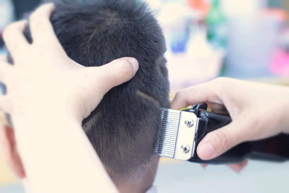 This low fade haircut provides structure and definition to this little boy's short hair length, making it a standout style.