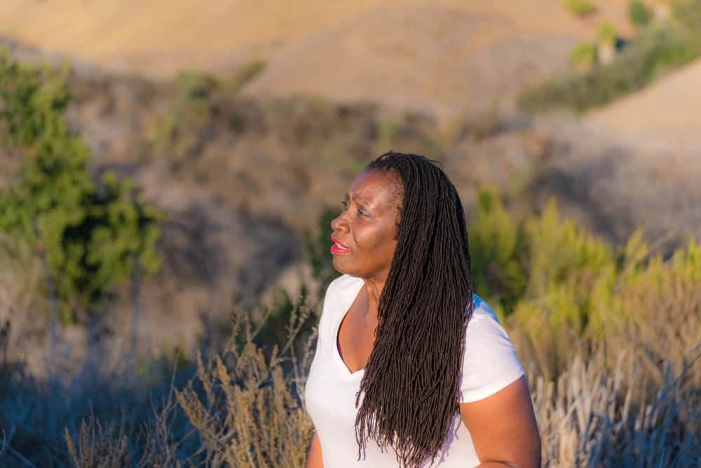 Sisterlocks air drying in the gentle sunlight are a testament to the daily upkeep needed to keep them feeling soft and healthy.