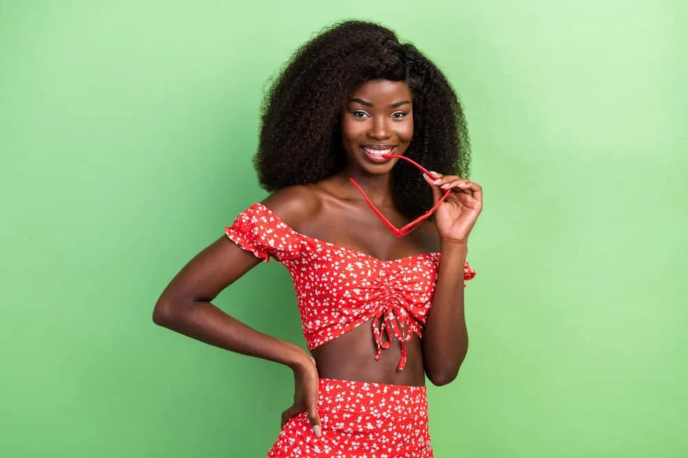 150% vs. 180% Density Curly Wig: Is 180 Density Better Than 150? 1 A cute young black girl with a curly hair wig made with type 4 natural hair density used to create many wavy hairstyles.