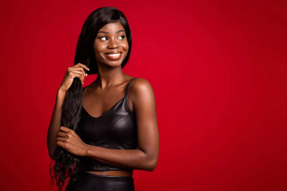 How Long Does Wig Glue Last? How to Make It Last Longer 3 A cute black girl with dark brown skin that likes to wear human hair wigs is wearing a human hair wig installation put on with waterproof glue.