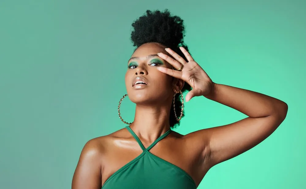 Protective Hairstyles for 4C Hair: 8 Low Manipulation Styles 5 An African female with a 4C hair texture wearing her own hair after removing flat twists on her short natural hair.