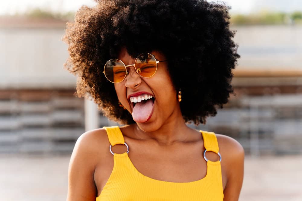 A beautiful African female showing off her natural hair growth with a beautiful wash-and-go style with sleek edges.