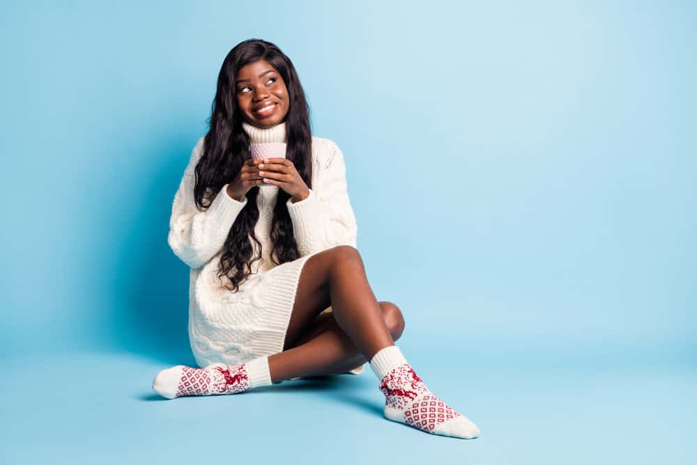 A black girl wearing a wig that's the same hair density as her low-density hair creating an age-realistic look.