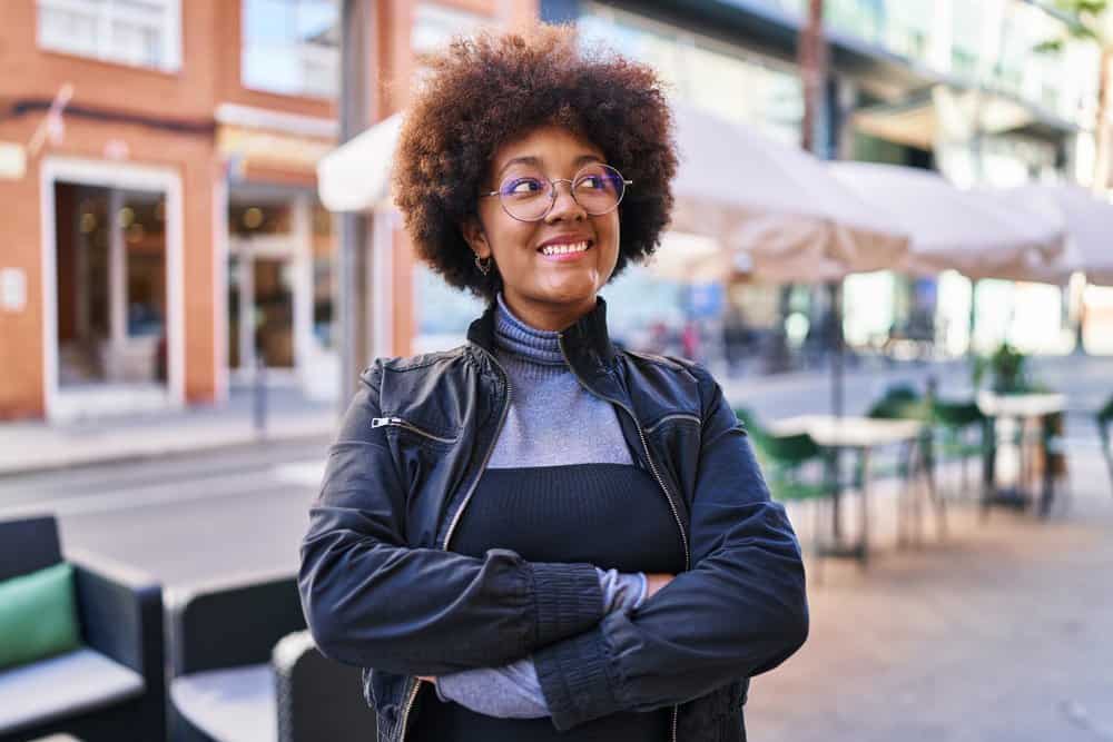 A beautiful African woman with thin curls that have a type 4 curl definition styled after a deep conditioning treatment.