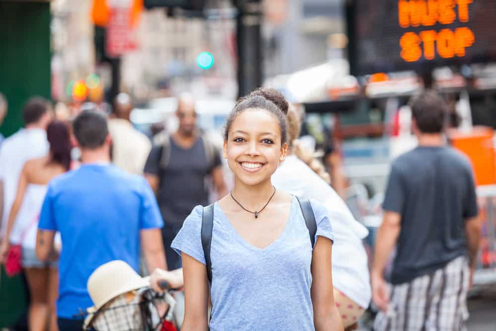 A cute young African American female with colored hair wants to kill lice with non-toxic shampoo.