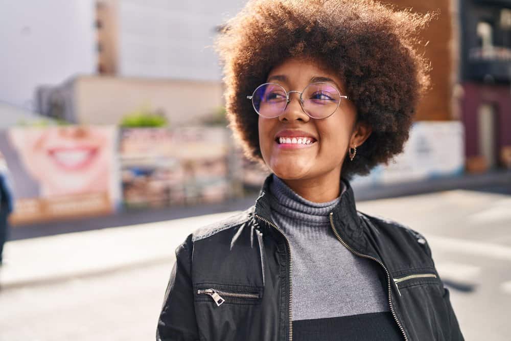 A beautiful black woman with thin hair wearing a wash 'n go to encourage more volume for her fine curls.