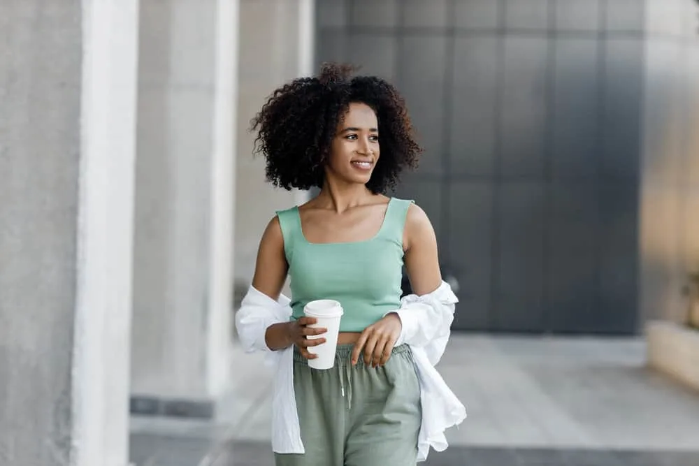 Does Curly Hair Shed More Than Straight Hair? How to Stop It? 7 A cute light-skinned black girl with bouncy curls after a deep conditioning treatment to reduce shedding.