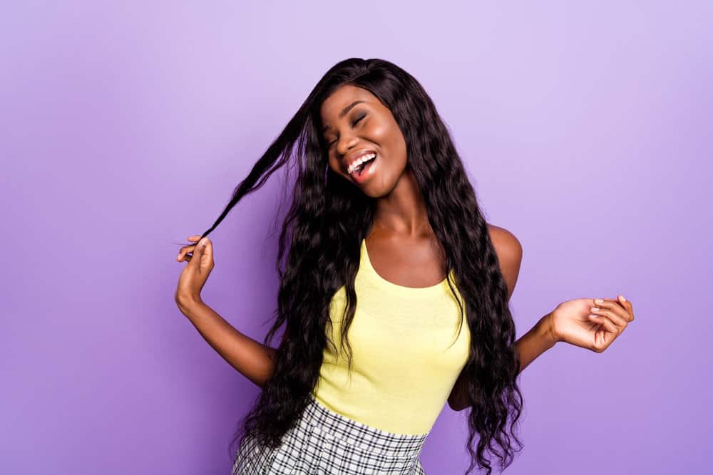 African American female wearing a lace wig made of synthetic hair secured with waterproof glue.