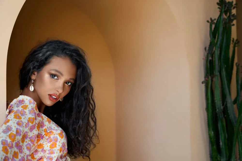 Ayurvedic Hair Growth: How to Use Ayurveda Hair Oil & Herbs 12 A gorgeous young African American lady used organic hair cleansers to promote hair growth and reduce hair fall.
