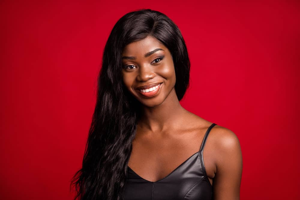 A young black female wearing a natural hair lace front wig made from real human hair with a natural-looking hairline.