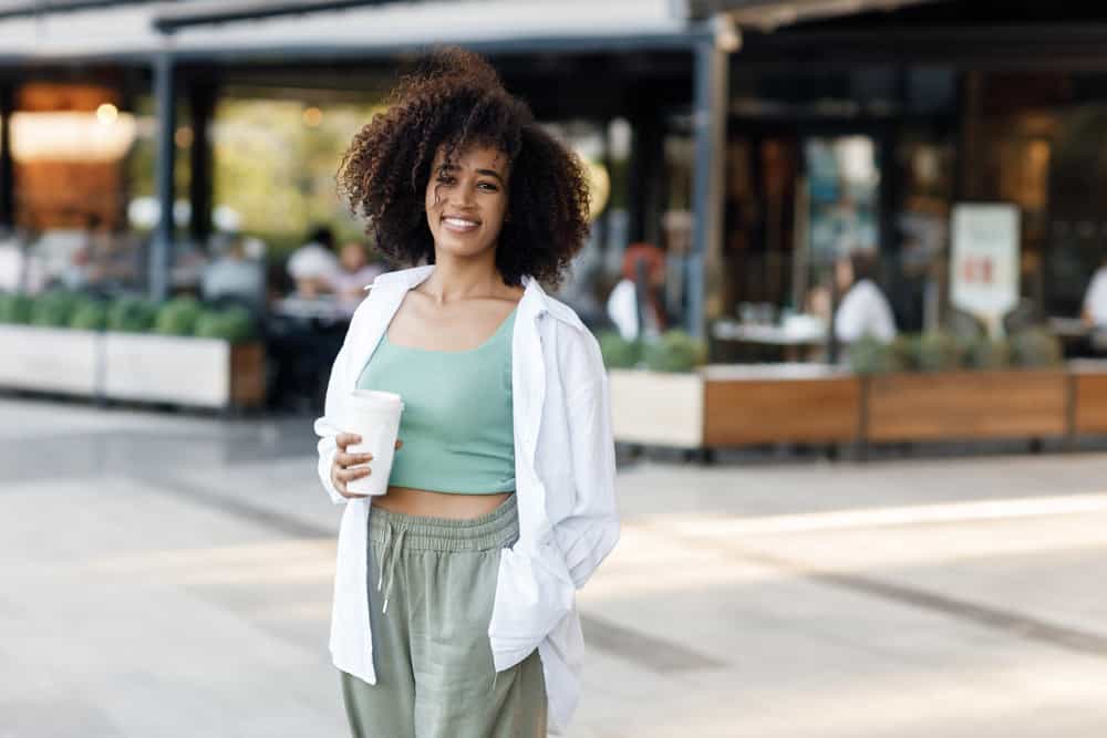 A young black girl that had hair falling out is showing off her new hairstyle following rapid new hair growth.