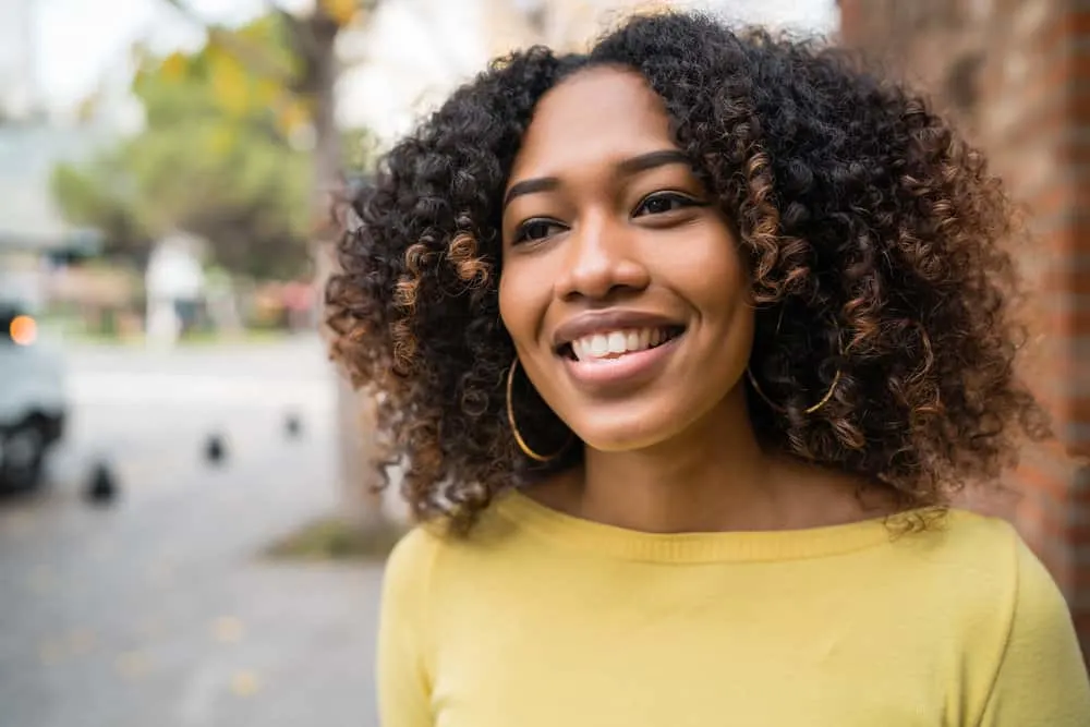 How to Deep Condition Hair at Home Naturally for Curly Hair 7 A cute mixed-race female with brittle hair regularly workouts in the city center with a beautiful waterfront view.