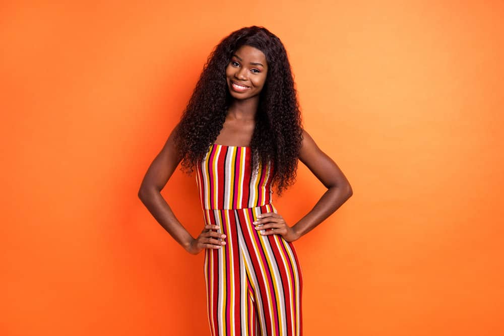 A beautiful African American female with natural-looking hair is wearing a high-density wig with thinning hair.