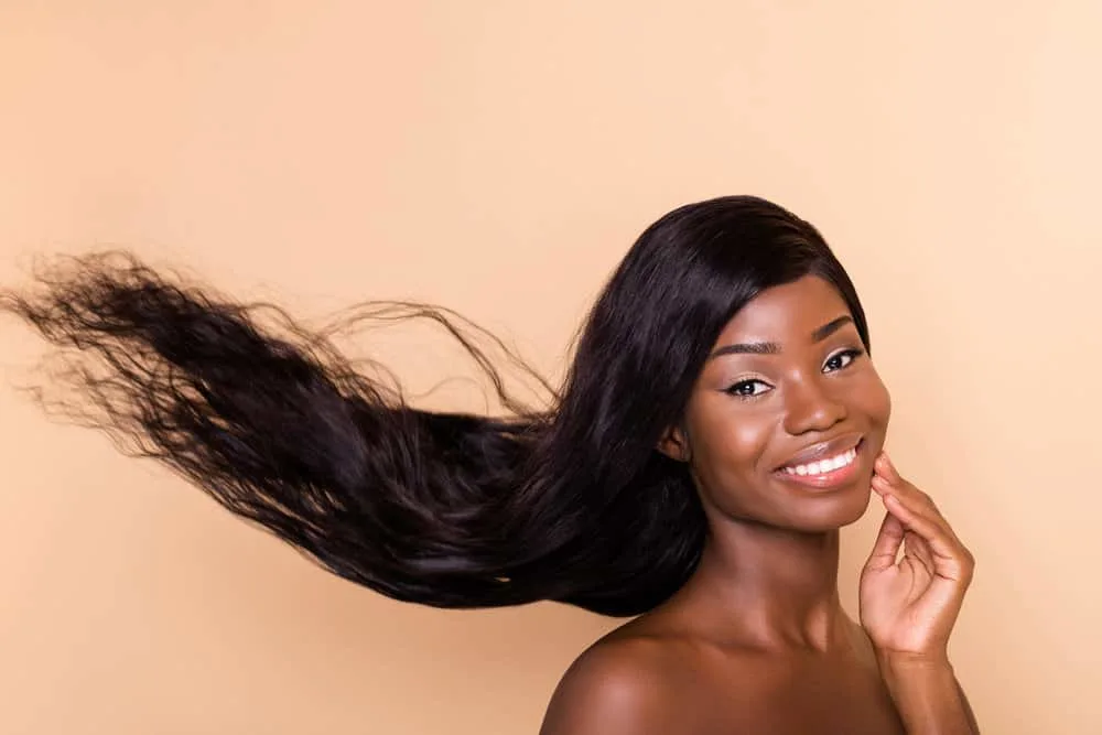 180 Wigs: What Does 180% Density Wig Mean? How's It Look? 5 A female with flawless skin wearing a black lighter-density wig with type 4 hair thickness for a fuller and thicker look.