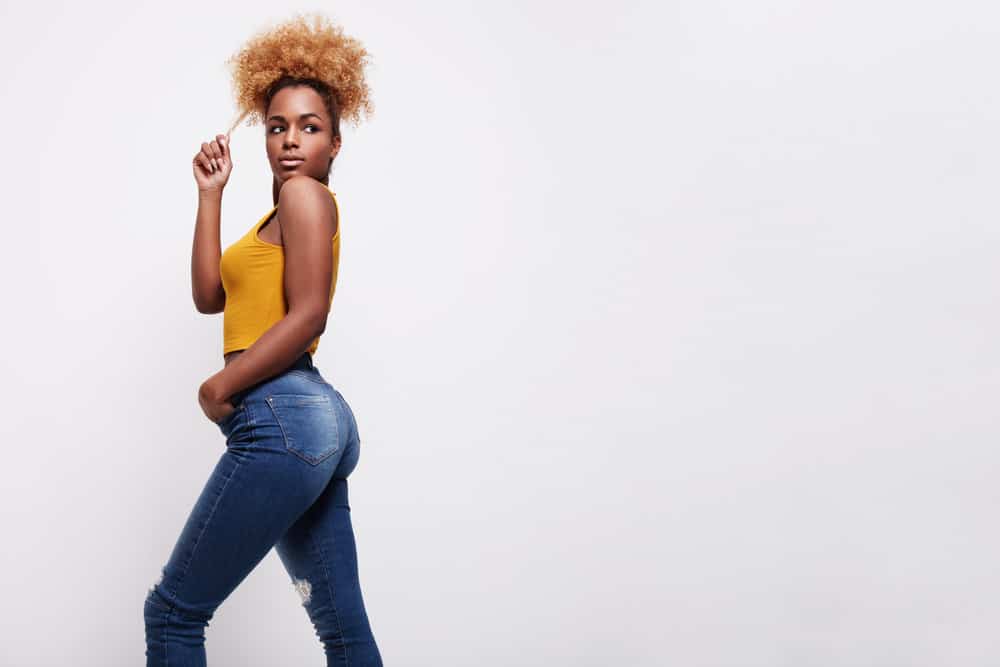 A fashionable African American female used the pineapple hair method to create a stunning casual updo hairstyle.