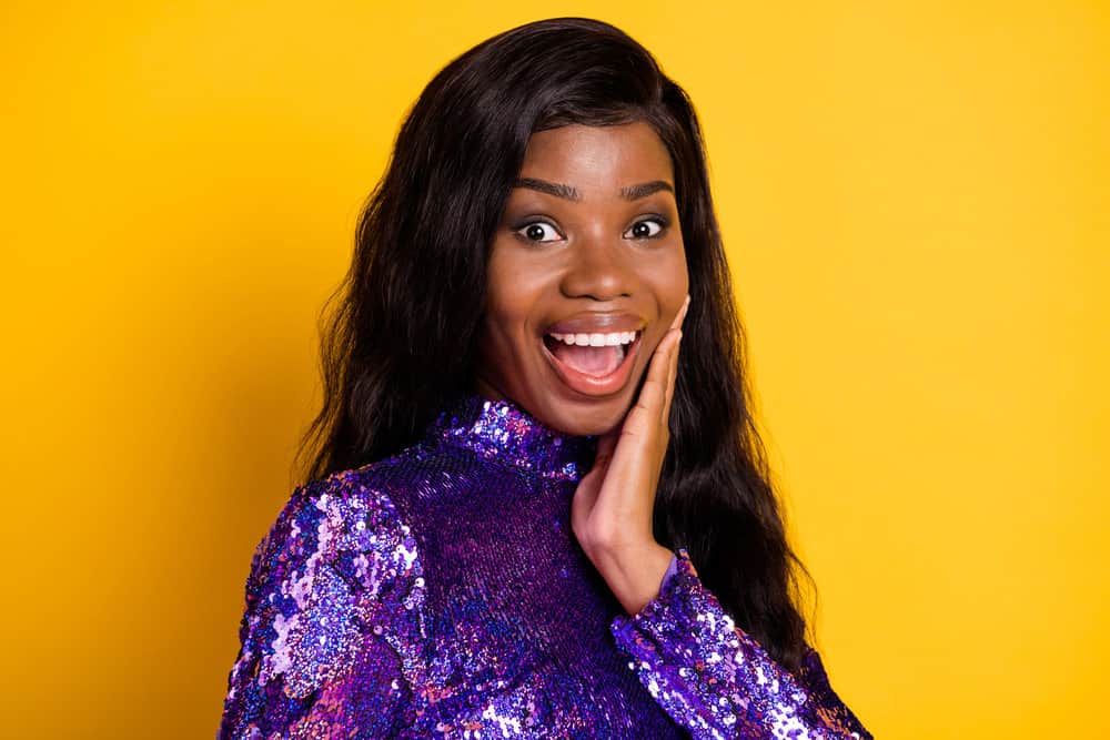 An African American female showcases one of her favorite lace wigs made with virgin hair strands.