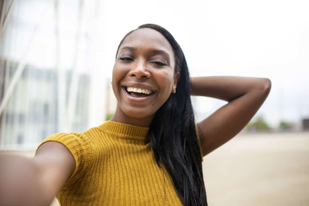 A cute black female with healthy hair has a straight hair type even though her hair is not curly anymore.