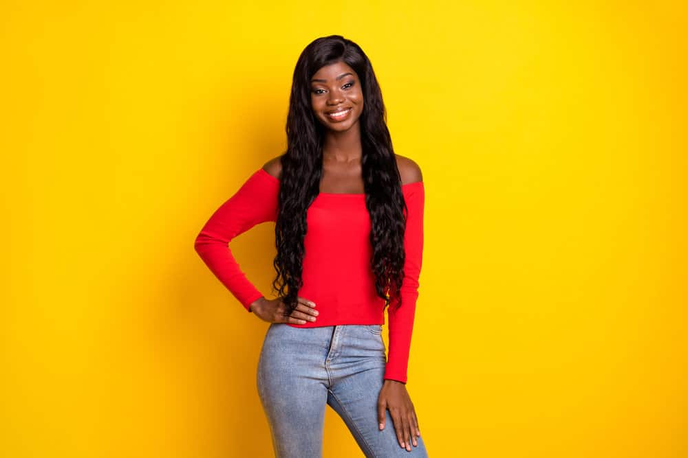 A sweet black female wearing a lace front wig without excess glue, which is typical with lace wigs and wig caps.