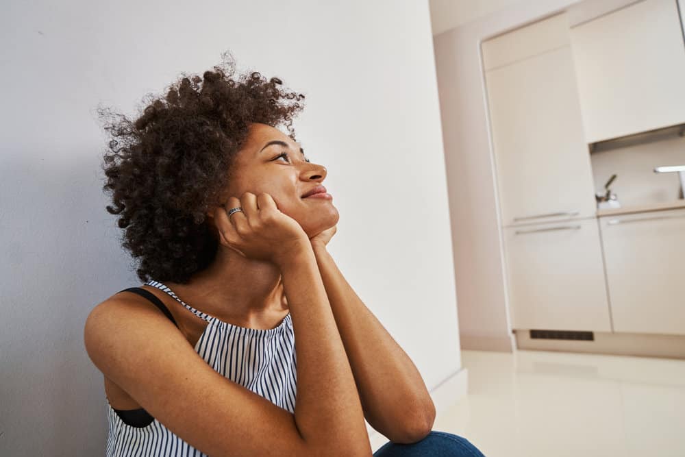 African American women avoiding a hairdryer because she is starting the Curly Girl Method