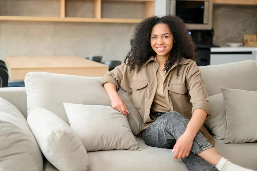 Finger Combing: What Is It and Step-by-Step How to Guide 7 African-American woman with healthy hair after treating her precious locks with natural oils to reduce hair breakage.
