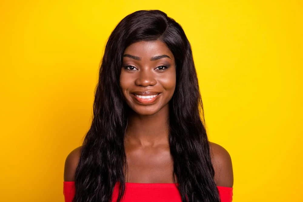 How to Put on a Lace Front Wig for Beginners: DIY Step-by-Step 5 An adorable African American female that often wears synthetic wigs to create long hair with a natural look.