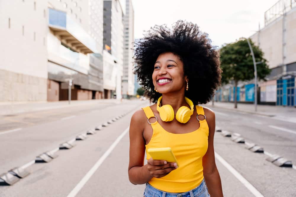 A cheerful black with manageable hair has been using medicated shampoos to make her long hair soft and pliable.