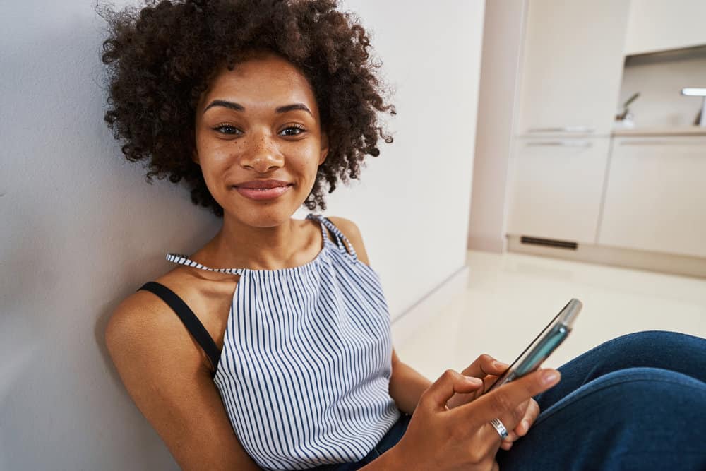 Women conditioning hair because the Curly Girl Method requires you to stop using shampoo