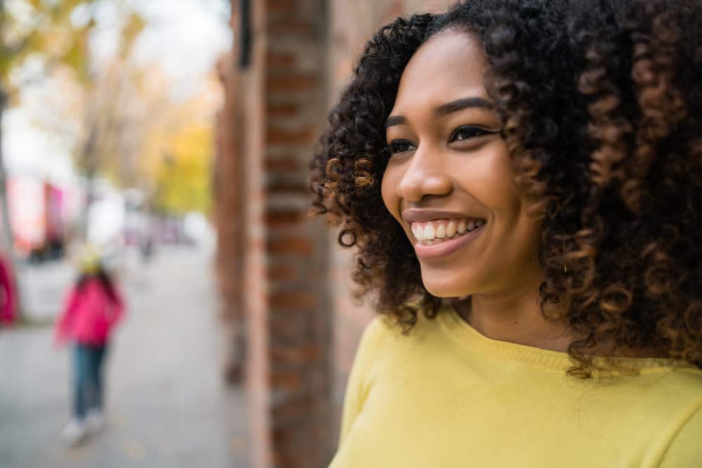 A black lady that experienced hair breakage used deep conditioning overnight to encourage healthy hair.