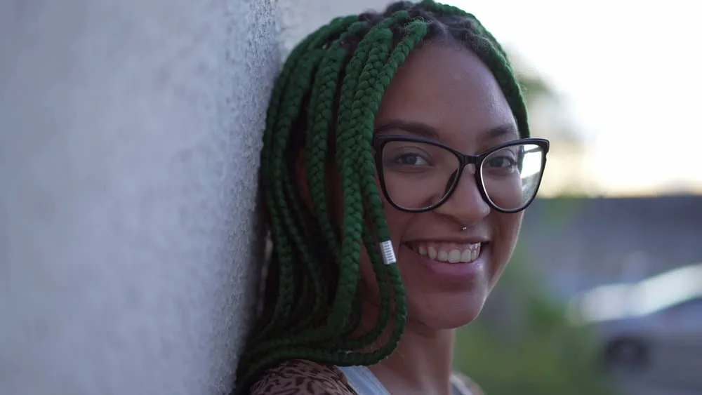 Why Do Braids Itch So Much? When You First Get Them? 2 A gorgeous black woman wearing a protective style covering her own hair and scalp with Kanekalon hair.