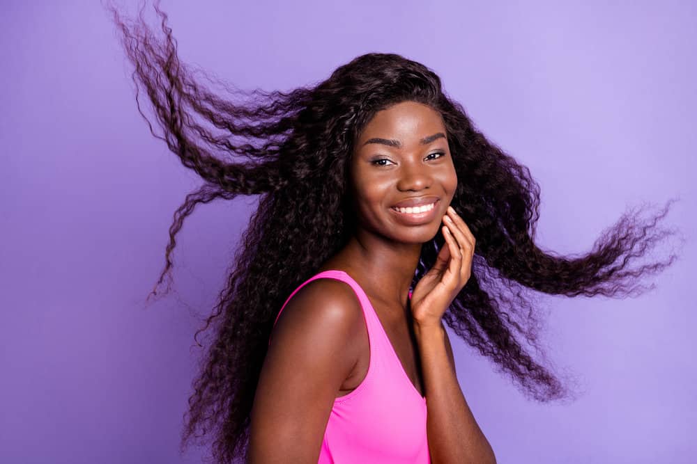 A lady wearing versatile hairpieces crafted from human hair bundles and half-hand-tied lace creates a natural look.