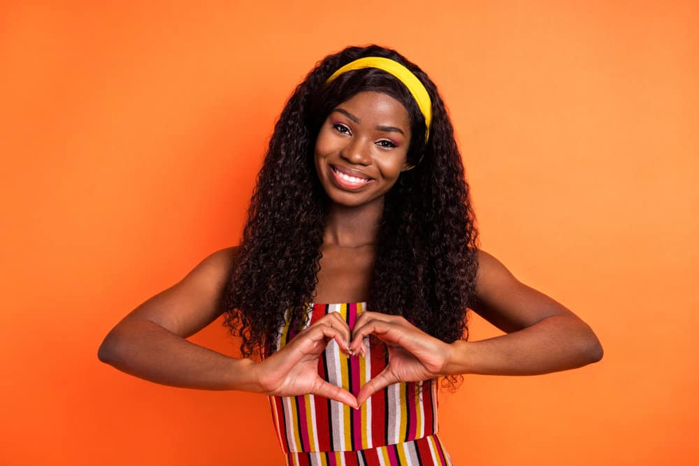 The lighter-density wig worn by this African American female is a full lace wig creating a natural and perfect look.