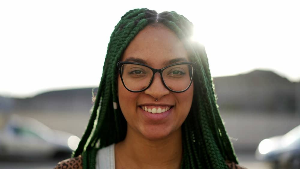 African American female using braids to grow her hair after experiencing permanent hair loss from an allergic reaction.