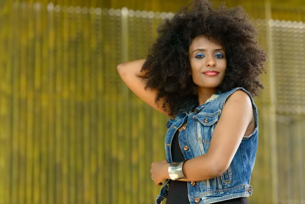 What Is High Porosity Hair and How to Care For It Step-By-Step 10 A young black girl with big, bouncy curls after using a deep conditioning mask and curly girl approved styling products.