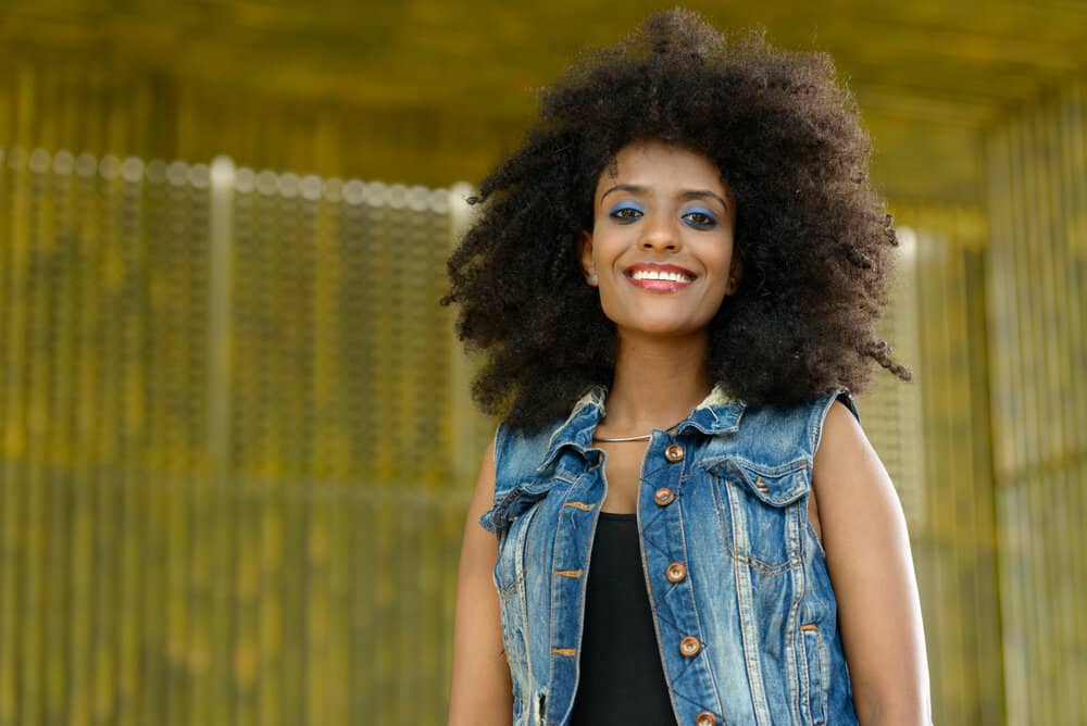 African American female wearing a black cotton t-shirt showing off her hair's texture with a bold afro hairstyle.