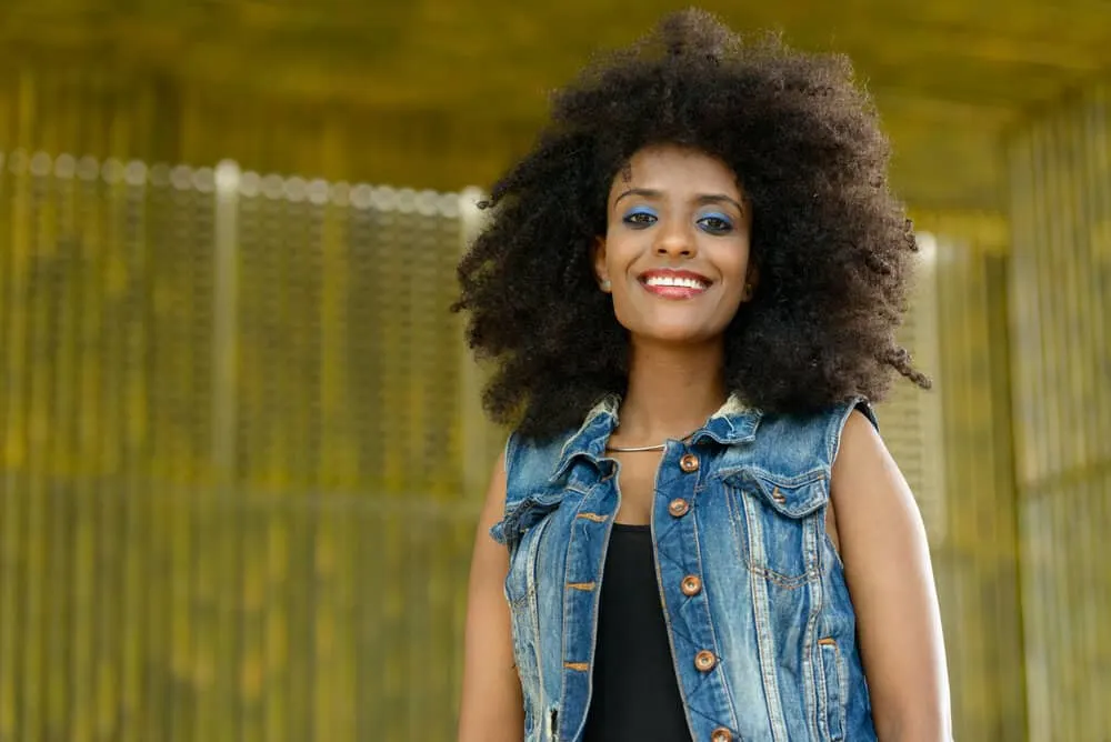 African American female wearing a black cotton t-shirt showing off her hair's texture with a bold afro hairstyle.