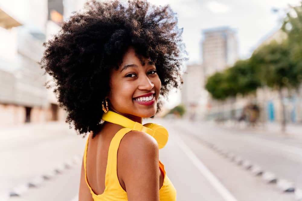 A black girl that keeps her normal hair soft by only using shampoo and conditioner products for curly or textured hair.