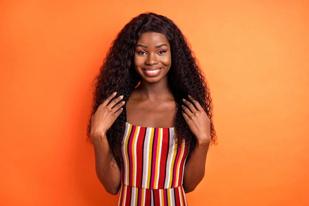 Is 150% Density Good for a Wig? How Thick Is a 150% Density Wig? 2 A young black girl with an authentic and cheerful look dons a lace wig with medium-density hair texture and fine hair.