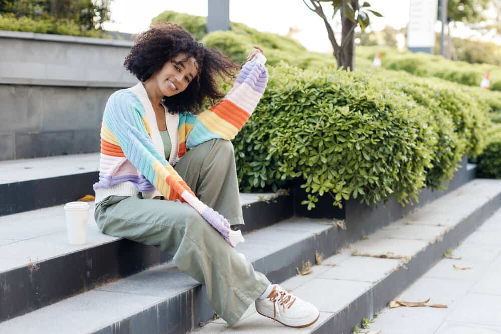 A cute African girl showing off her natural hair after using a combo of clarifying shampoos and natural oils.